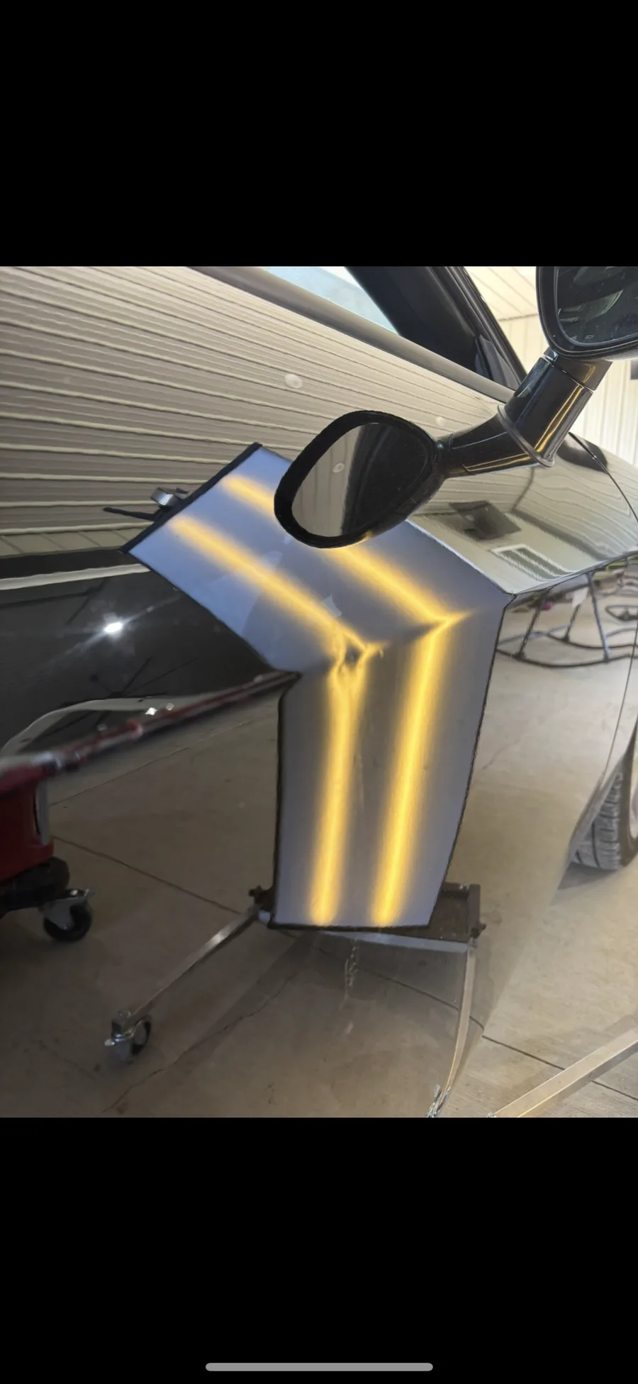 Vehicle body panel removed and positioned on a stand for LED line-board inspection